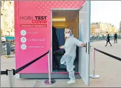  ?? AFP ?? A health worker enters in a Covid-19 testing booth in Paris.