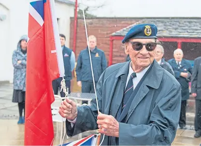  ?? Picture: Paul Smith. ?? Retired Merchant Navy captain Sandy Davidson raises the Red Ensign during a ceremony at Arbroath Signal Tower Museum.