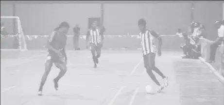  ??  ?? Trayon Bobb [right] of Rio All-Stars in the process of initiating an attack against Alexander Village at the National Gymnasium in the Dragon Stout Community Cup.