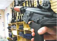  ?? ASSOCIATED PRESS FILE PHOTO ?? An employee of North Raleigh Guns demonstrat­es how a “bump stock” works at the Raleigh, N.C., shop in 2013.