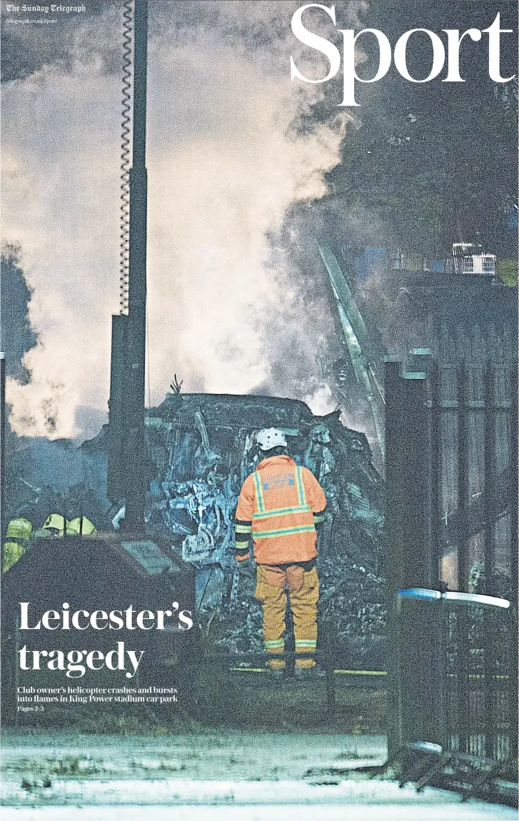  ??  ?? Nightmare vision: A member of the emergency services inspects the smoulderin­g shell of the helicopter belonging to Leicester owner Vichai Srivaddhan­aprabha after it crashed when leaving the stadium following their match against West Ham United yesterday