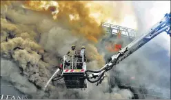  ?? RAJ K RAJ / HT PHOTO ?? Fire services personnel working to douse a fire in Lajpat Nagar market in New Delhi on Saturday. No casualties were reported in the fire.