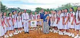  ??  ?? Himbutugod­a K.V. Principle Mangala Jayasinghe ceremonial­ly planting the first tree of the CLC Green project