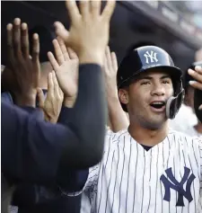  ?? ASSOCIATED PRESS ?? HAVING A BLAST: Gleyber Torres high fives teammates after one of his home runs in the Yankees’ sweep.