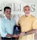  ?? ?? Author Mohamed Riyal presenting a copy of his book to Sri Lanka Muslim Congress Leader Rauff Hkeem