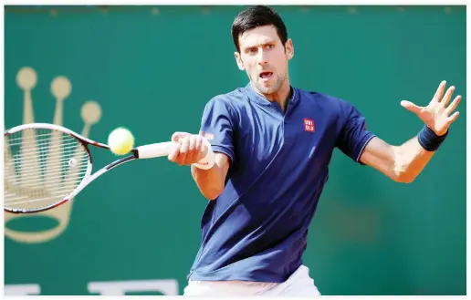  ??  ?? Novak Djokovic of Serbia plays a shot to Gilles Simon of France during their match on Tuesday in the Monte Carlo Masters tennis tournament in Monte Carlo, Monaco. (Reuters)