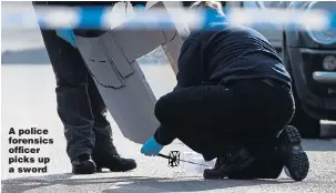  ?? Picture: JOEL GOODMAN/LNP ?? A police forensics officer picks up a sword
