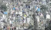  ?? MARCO UGARTE — THE ASSOCIATED PRESS ?? Visitors arrive at the Valle de Chalco municipal cemetery on the outskirts of Mexico City to pay their respects to their dead on Sunday.