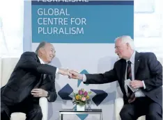  ?? FRED CHARTRAND/THE CANADIAN PRESS ?? Gov. Gen. David Johnston, right, and the Aga Khan shake hands at the opening for the new home of the Global Centre for Pluralism in Ottawa.