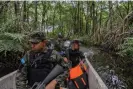  ?? ?? Park ranger Adonias Cruz and colleagues patrol a mangrove lagoon in Blanca Jeannette Kawas national park looking for signs of illegal oil palm