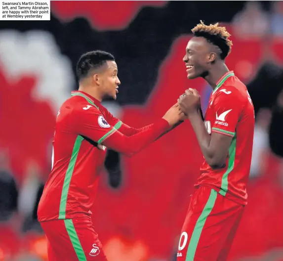  ??  ?? Swansea’s Martin Olsson, left, and Tammy Abraham are happy with their point at Wembley yesterday