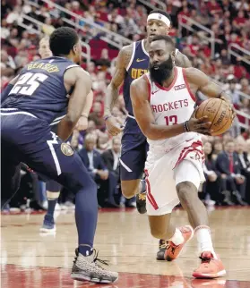  ?? AP FOTO ?? ON FIRE. James Harden (right) attacks defender Malik Beasley in the second half of the Houston Rockets’ win over the Denver Nuggets.