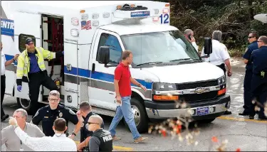  ?? NWA Democrat-Gazette/DAVID GOTTSCHALK ?? A first responder exits an ambulance before inspecting the hood of a small plane as emergency responders secure the scene of a small airplane crash Nov. 3 on Martin Luther King Boulevard in Fayettevil­le.