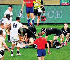  ??  ?? Feet and inches: Courtney Lawes (No 20) edges forward to charge down TJ Perenara’s kick but he was ruled offside as he was ahead of the hindmost point of the ruck (circled)