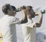  ??  ?? 0 England batsman Dawid Malan plays a stroke on his way to an unbeaten 110 on day one of the third Test. Left, Malan and Jonny Bairstow take a drinks break during their unbroken stand of 174.