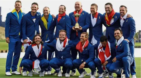  ??  ?? Champions!: Team Europe posing with the trophy after winning the Ryder Cup in SaintQuent­in-en-Yvelines on Sunday. — AP