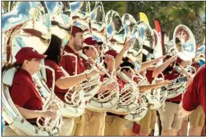  ?? ?? Razorback marching band tuba players during a beach performanc­e