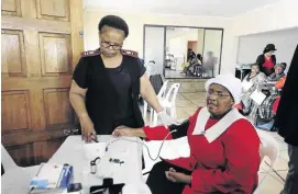  ?? / THULANI MBELE ?? Methodist Church member Queen Magagula, 65, has her blood pressure tested by nurse Rosemary Kekana at the church's premises in Mfuyaneng, Tembisa. Doctors were offering free health services.