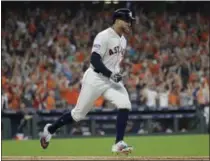  ?? DAVID J. PHILLIP - THE ASSOCIATED PRESS ?? Houston Astros’ George Springer celebrates his solo home run against Cleveland Indians pitcher Corey Kluber during fifth inning in Game 1 of an American League Division Series baseball game Friday, Oct. 5, 2018, in Houston.