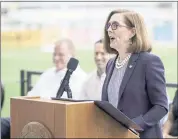  ?? CRAIG MITCHELLDY­ER — THE ASSOCIATED PRESS ?? Oregon Gov. Kate Brown announces the end of the state’s COVID-19 restrictio­ns in Portland, Ore., in June Since then, Brown has mandated masks for schools and vaccinatio­ns for all school staffers after a surge in COVID-19 infections.