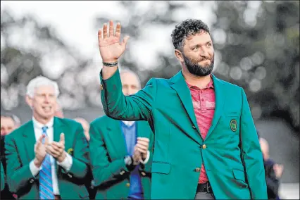  ?? David J. Phillip
The Associated Press ?? Defending Masters champion Jon Rahm will bring his green jacket to Augusta this week and compete against Scottie Scheffler, the undisputed No. 1 player in the world, for the first time this year.