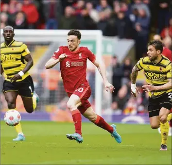  ?? Jon Super / Associated Press ?? Liverpool’s Diogo Jota, center, vies for the ball with Watford’s Kiko Femenia, right, during the English Premier League match on Saturday.