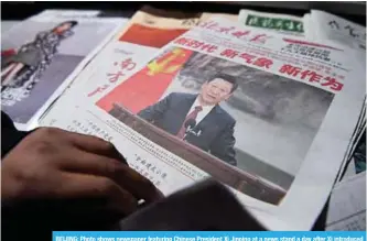  ?? —AFP ?? BEIJING: Photo shows newspaper featuring Chinese President Xi Jinping at a news stand a day after Xi introduced China’s new Politburo Standing Committee, the nation’s top decision making body, in Beijing.