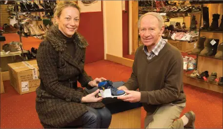  ??  ?? Caroline O’Halloran (Causeway) chooses a nice pair of runners with the help of David at David Costello Shoes, Castleisla­nd.