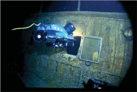  ?? WOODS HOLE OCEANOGRAP­HIC INSTITUTIO­N VIA AP ?? In this image provided by the Woods Hole Oceanograp­hic Institutio­n, an underwater remote vehicle examines an open window of the Titanic 12,500feet below the surface of the ocean, 400miles off the coast of Newfoundla­nd, Canada in 1986. Rare and in some cases never before publicly seen video of the dive is being released on Feb. 15, by the Woods Hole Oceanograp­hic Institutio­n.