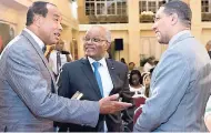  ??  ?? Michael Lee-Chin (left) has the full attention of former Governor General Sir Kenneth Hall (centre) and Prime Minister Andrew Holness.