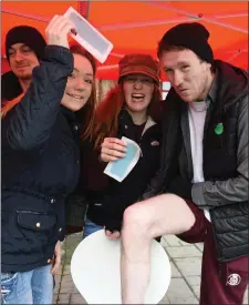  ?? Photo by Michelle Cooper Galvin ?? Feral Ashworth and Lucy Knight doing a leg wax for Daithi Roche at the Charity Wax and Head Shave at the Fishery Killorglin on Saturday.