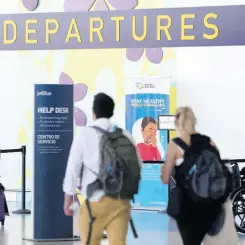  ??  ?? Outbound travellers head to the departure hall at the Norman Manley Internatio­nal Airport in Kingston on Sunday.