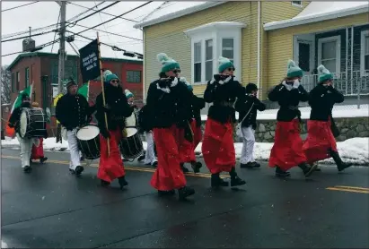  ?? Jonathan Bissonnett­e photo ?? Above, despite the wintry conditions Saturday morning and afternoon, bands played the fife, brass instrument­s and party music to entertain the crowds at the annual St. Patrick’s Parade in Pawtucket. Below, plows and sanders had to treat local roads Saturday as a pesky storm rolled in around daybreak, dumping as much as 6 inches in certain locales.