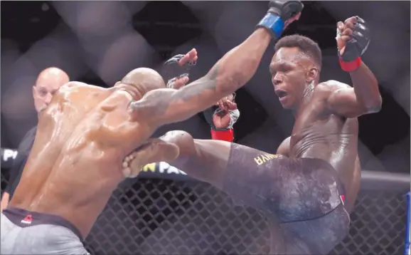  ?? Photo: TechiLive.in ?? Still the king… Israel Adesanya (right) won a unanimous decision in a rematch against Marvin Vettori to defend his middleweig­ht championsh­ip belt on Saturday.