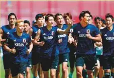  ?? AFP ?? Japan’s Yuto Nagatomo (left), Genki Haraguchi (centre) and Tomoaki Makino take part in a training session.