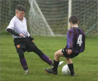  ??  ?? Callum Farrell of Wexford Albion in a tussle for the ball with Lee Doyle (Courtown Hibs).