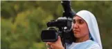  ??  ?? Sarah, fellow nun of Maria Valentina de los Angeles records a music video at a convent.