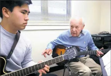  ?? Nate Guidry/Post-Gazette ?? Joe Negri teaches guitar lessons to University of Pittsburgh student Stephen Chung last spring.