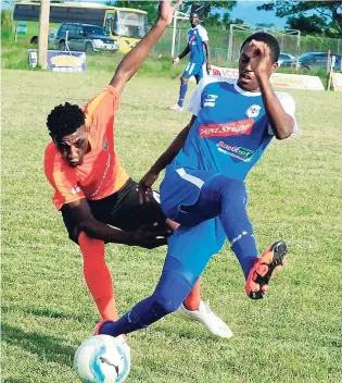  ??  ?? Tivoli Gardens’ Tevin Shaw (left) loses his balance while he is being tackled by Reno FC’s Kavar Walker during their Red Stripe Premier League match on November 20 at the Frome Sports Ground. Tivoli won 2-1.