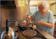  ?? REBECCA BLANCHARD — DIGITAL FIRST MEDIA ?? Anna Brown helps to prepare shepherd’s pie which was served at Hope Rescue Mission on Friday, March 17.