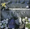  ?? THE ASSOCIATED PRESS ?? Fans still leave bats, balls, beer and other items on Babe Ruth’s grave in Hawthorne, N.Y.