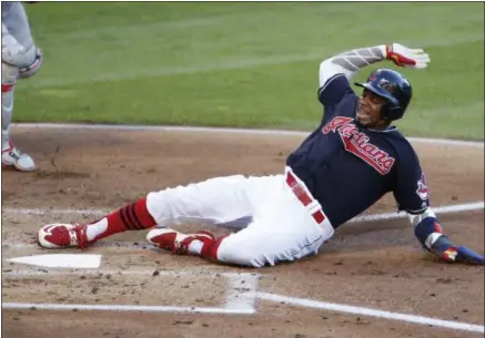  ?? RON SCHWANE — THE ASSOCIATED PRESS ?? The Indians’ Rajai Davis scores on a passed ball by Nationals catcher Wilson Ramos during the first inning on July 26 at Progressiv­e Field.