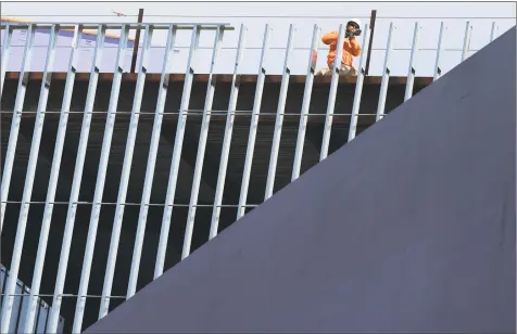  ?? Erik Trautmann / Hearst Connecticu­t Media ?? A worker in March at the site of the SoNo Collection mall under constructi­on in Norwalk.