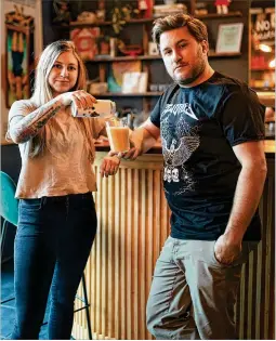  ?? COURTESY OF BEAU KESTER ?? Liz Massey pours a beverage alongside her husband, James Massey, in Smol Bar. Two Tides Brewing Co. recently opened the new bar on its first level, offering curious and tasty libations and tapas-inspired bites.