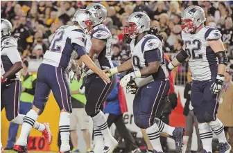  ?? STAFF PHOTO BY NANCY LANE ?? GETTING IT DONE: Tom Brady congratula­tes LeGarrette Blount on his touchdown in the fourth quarter of the Patriots’ win over Pittsburgh on Sunday.