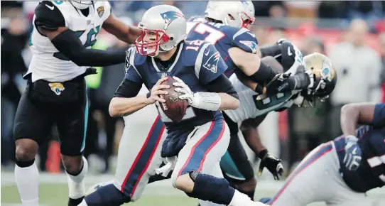  ?? CHARLES KRUPA/THE ASSOCIATED PRESS ?? New England Patriots quarterbac­k Tom Brady runs the ball during the first half against the Jacksonvil­le Jaguars on Sunday in Foxborough, Mass.