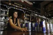  ?? RICH PEDRONCELL­I — THE ASSOCIATED PRESS ?? Bartender Courtney Schrag places beverage cans on the bar as she other employees prepare to close de Vere’s Irish Pub in Sacramento Tuesday, March 17. The pub, which would normally be packed with St. Patrick’s Day revelers, is serving take-out food until 6p.m. when it will close due to Gov. Gavin Newsom’s guidelines restrictin­g bars and restaurant­s due to the coronaviru­s outbreak.