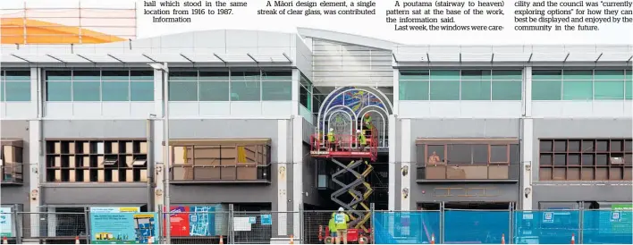  ?? Photo / Mead Norton ?? Contractor­s carefully remove a large stained glass window from the main entrance of the Tauranga City Council’s former building.