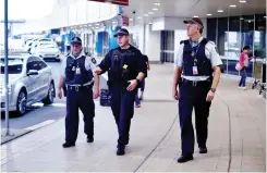  ??  ?? Police walk outside the internatio­nal terminal as they patrol Sydney Airport on Monday.(AFP)