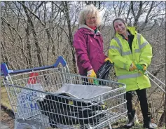  ??  ?? Mary and Luize Vinkalne stashed their litter haul from Glengallan Road near the hospital in an abandoned shopping trolley.